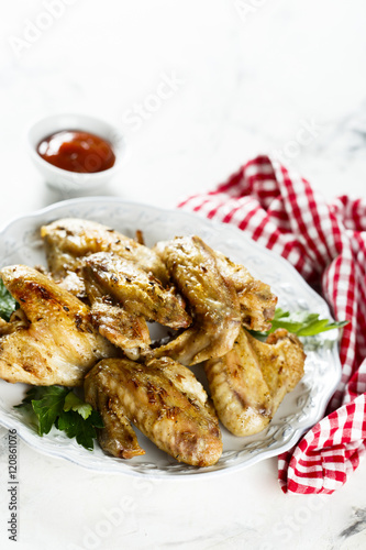 Baked chicken wings with parsley and tomato sauce