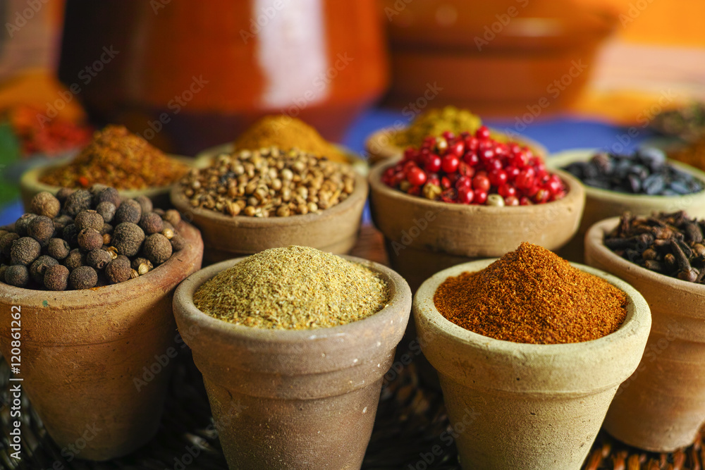 Collection of different spices in old clay bowls in colorful oriental style Collection of different spices in old clay bowls in colorful oriental style
