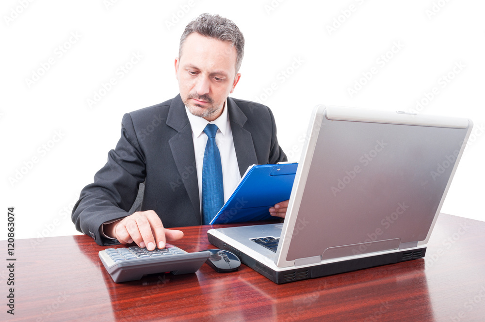 Man at office holding clipboard and calculating Man at office holding clipboard and calculating