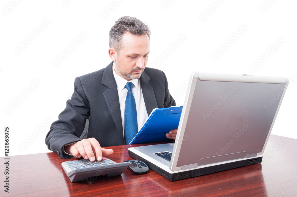 Man at office holding clipboard and calculating Man at office holding clipboard and calculating