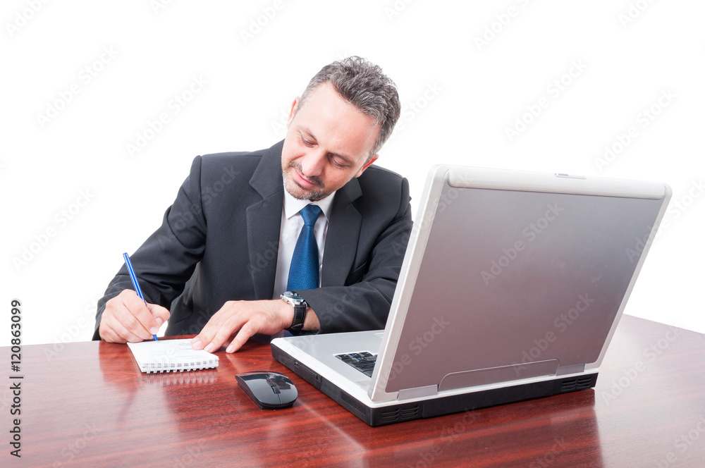 Business man at office writing in notepad Business man at office writing in notepad