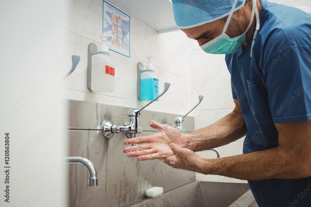 Male surgeon washing his hands Male surgeon washing his hands