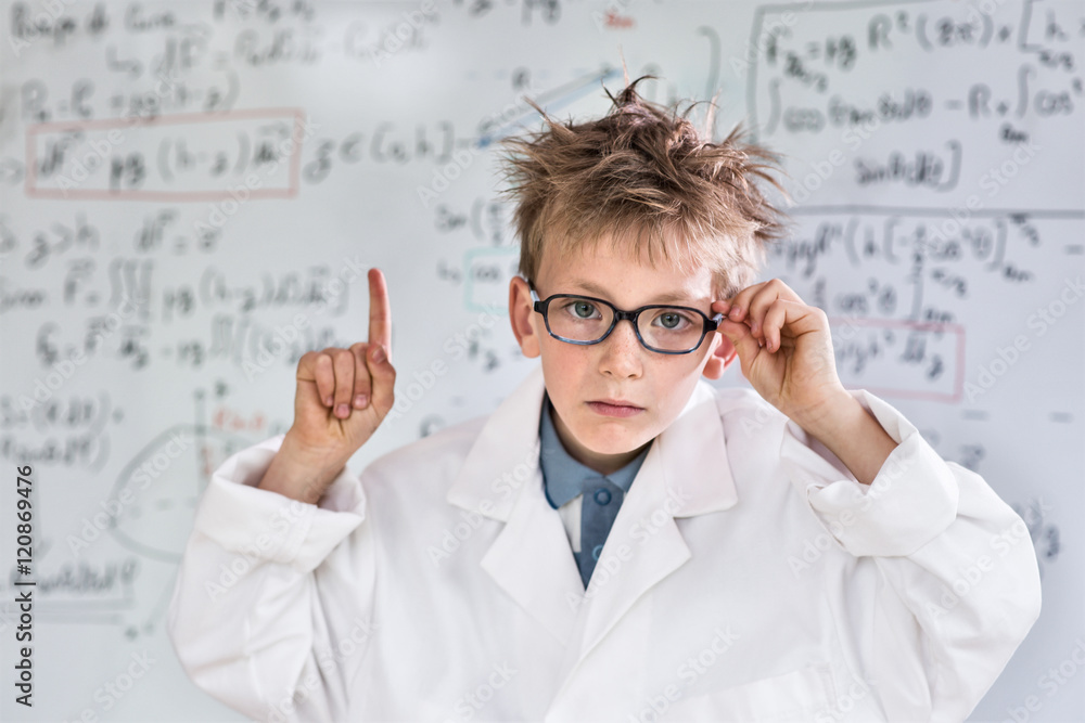 young funny genius posing in front of a board wiht math calculs young funny genius posing in front of a board wiht math calculs
