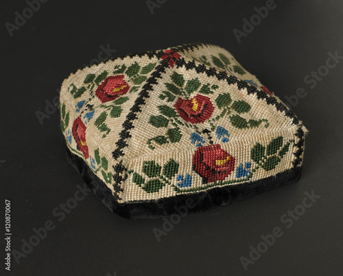 colorful traditional asian skullcap cap on a dark background photo