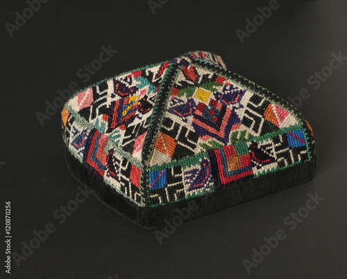 colorful traditional asian skullcap cap on a dark background