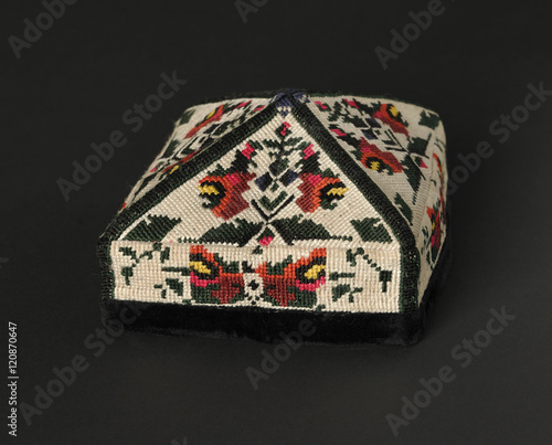 colorful traditional asian skullcap cap on a dark background photo