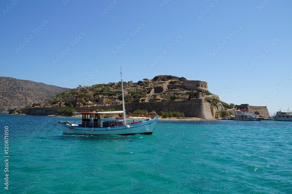 A boat in front of Spinalonga island, Greece