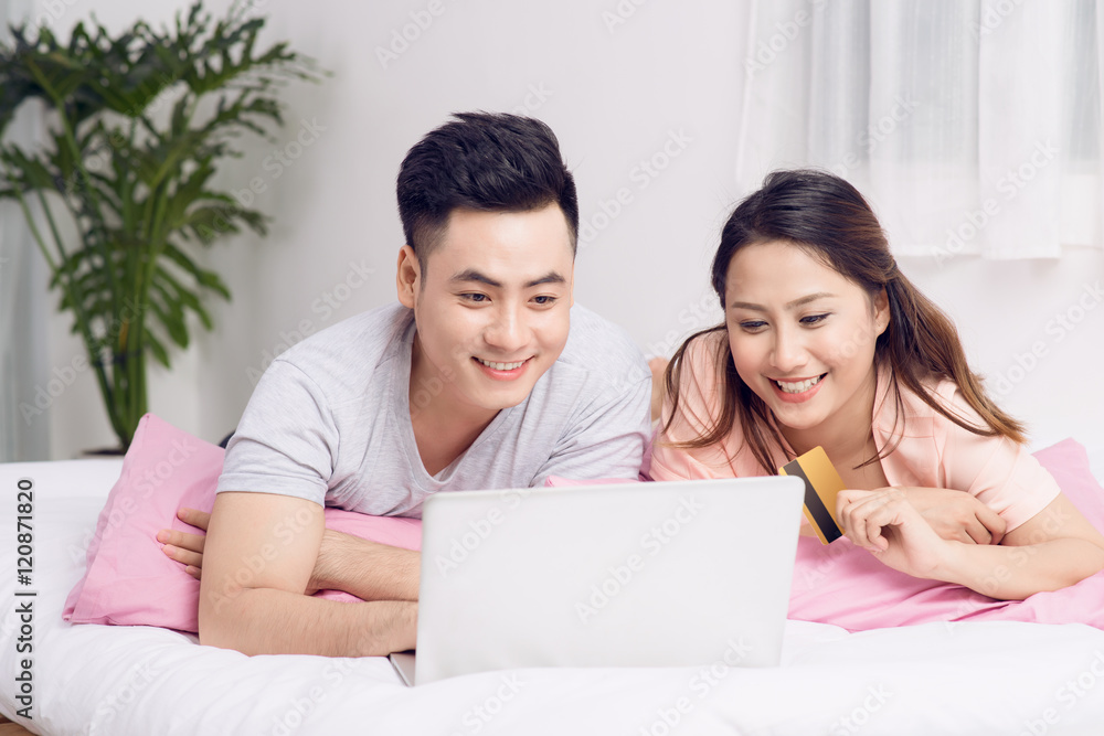 Young asian couple surfing on internet and shopping with laptop Young asian couple surfing on internet and shopping with laptop
