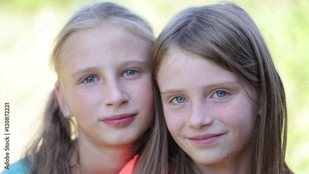 Portrait of two beautiful young girls,outdoor, portrait children close up Portrait of two beautiful young girls,outdoor, portrait children close up