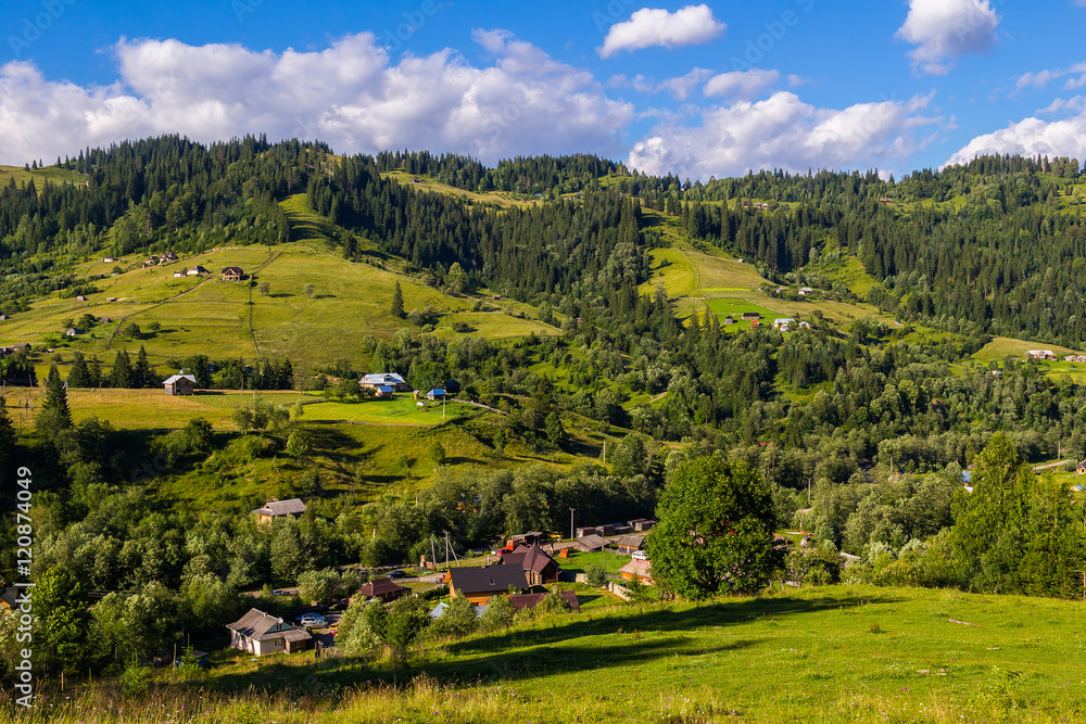 Rural houses in village Dzembronia at Carpathian mountains, nature summer landscape, Ukraine.
