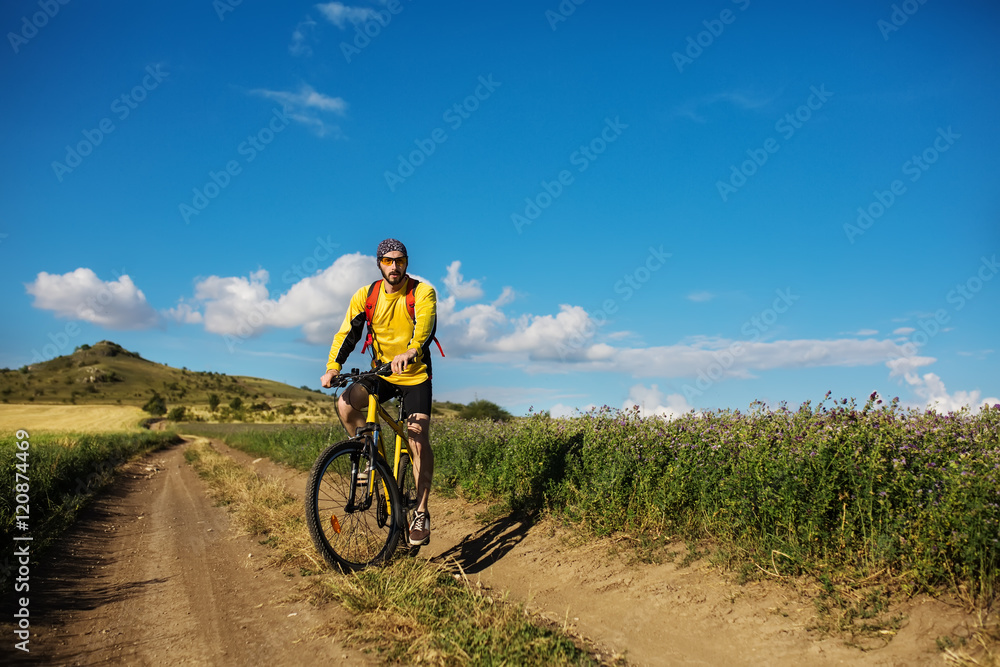 young bright man on mountain bike