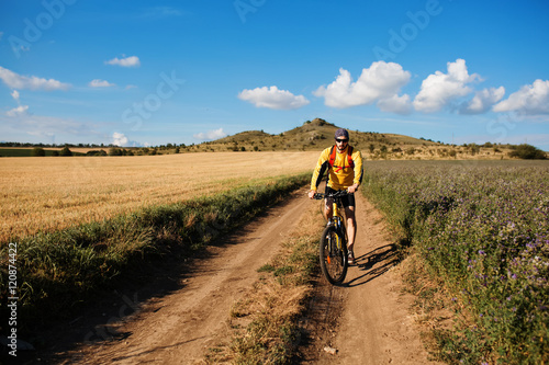 young bright man on mountain bike