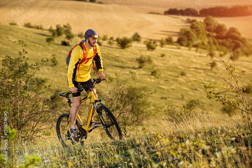 young bright man on mountain bike