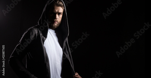 Baerded man in white t-shirt on black background
