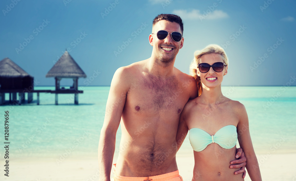 happy couple in swimwear hugging on summer beach happy couple in swimwear hugging on summer beach