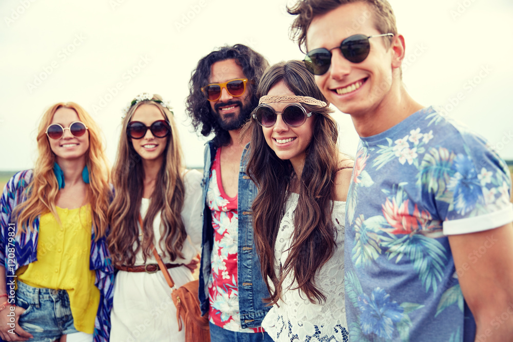 smiling young hippie friends outdoors