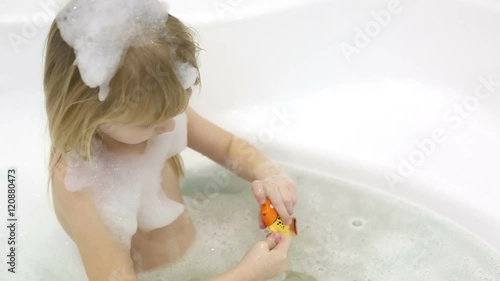 Little girl taking a bath.