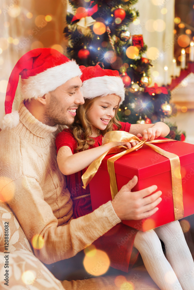 smiling father and daughter opening gift box smiling father and daughter opening gift box