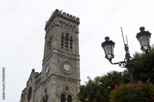 Church in Saint Lary in front of a lamppost, France photo