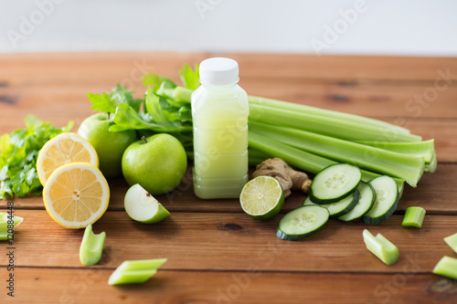 close up of bottle with green juice and vegetables