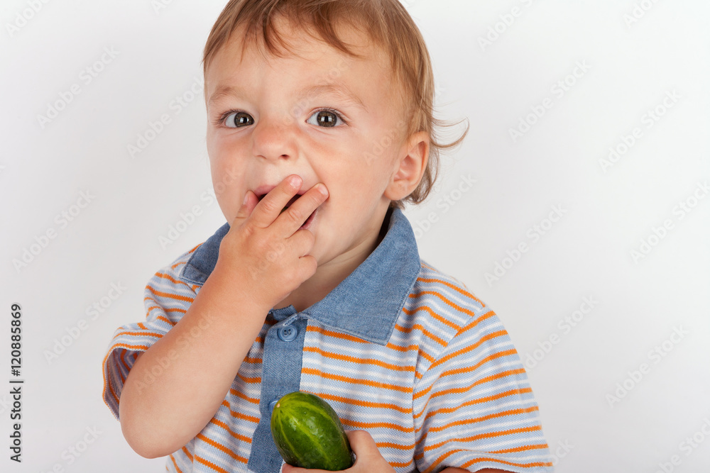 Fototapeta premium Hungry baby boy eating cucumber