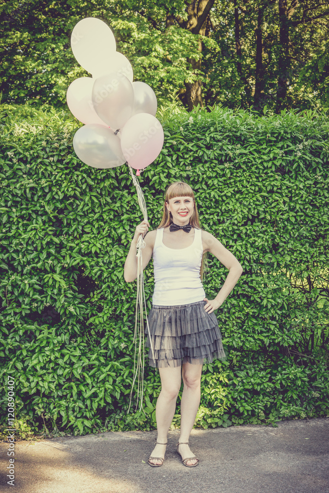 Beautiful hipster girl celebrating hen-party.Young sexy woman with long hair evening makeup wearing light fluffy skirt and posing outdoors in the city urban style in summer Beautiful hipster girl celebrating hen-party.Young sexy woman with long hair evening makeup wearing light fluffy skirt and posing outdoors in the city urban style in summer