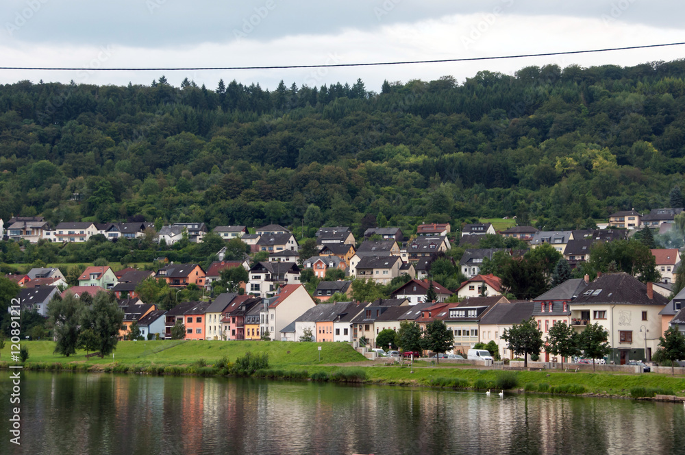 River, houses, forest and sky. On the one side of the Moselle river is Germany (in the picture), on the other is Luxembourg.