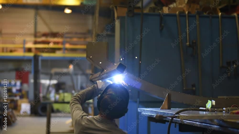 Metalworker welding in manufacture plant Metalworker welding in manufacture plant