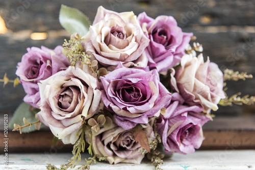 Pink roses bouquet over blur background