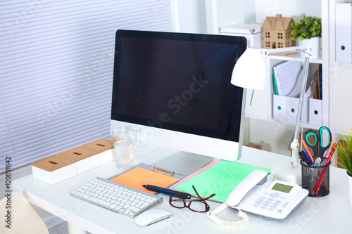 Designer working desk with computer and paperwork © lenetsnikolai