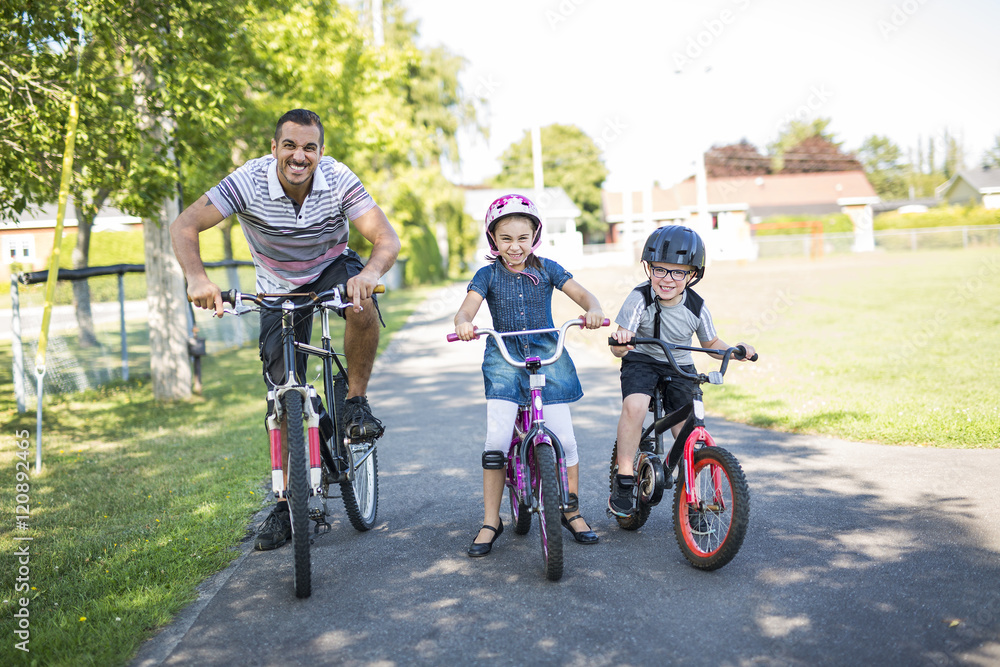 Dad With Daughter Son Riding Bikes In Park Dad With Daughter Son Riding Bikes In Park