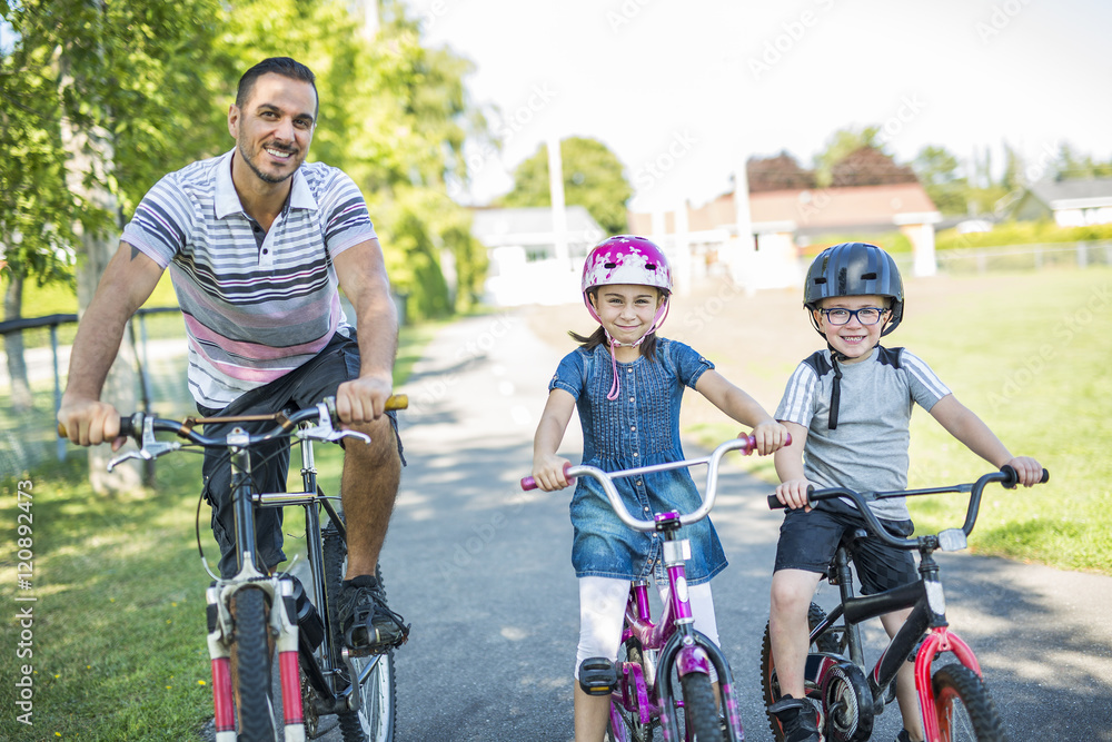 Dad With Daughter Son Riding Bikes In Park Dad With Daughter Son Riding Bikes In Park