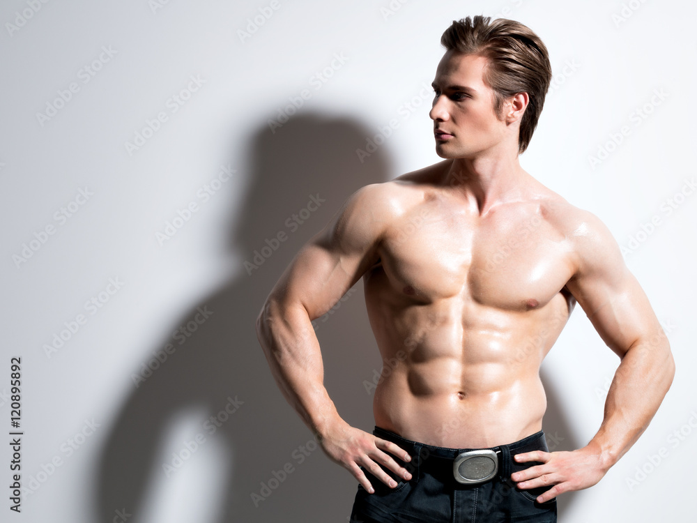 Handsome muscular young man posing at studio. Handsome muscular young man posing at studio.