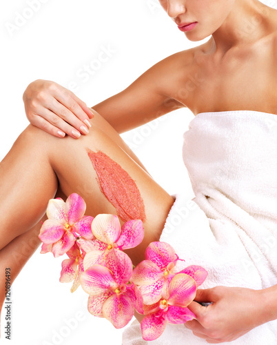 The woman with a beautiful with flowers body using a scrub