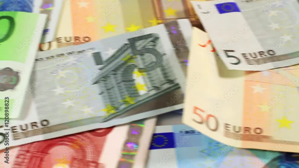 Money and Financials - Closeup dolly across banknotes. Camera motion over distributed Euro money.
Money and Financials - Closeup dolly across banknotes. Camera motion over distributed Euro money.