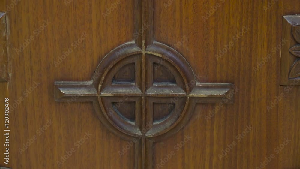 The metal cross sculptures on the bench inside the Gothic Church in Kylemore Abbey in Ireland