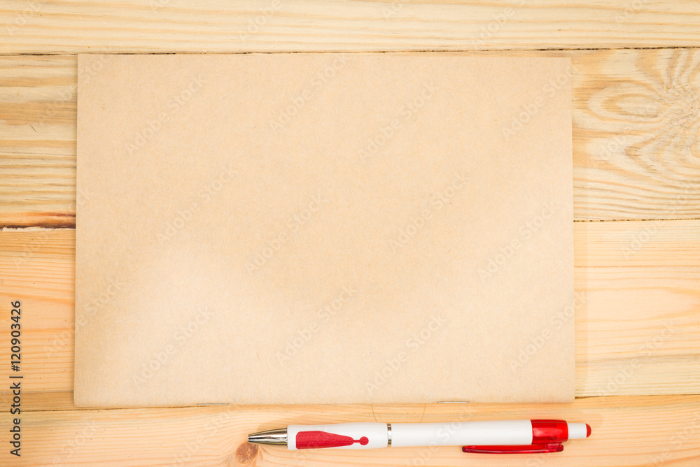 Obraz premium notebook and black pen with wooden background