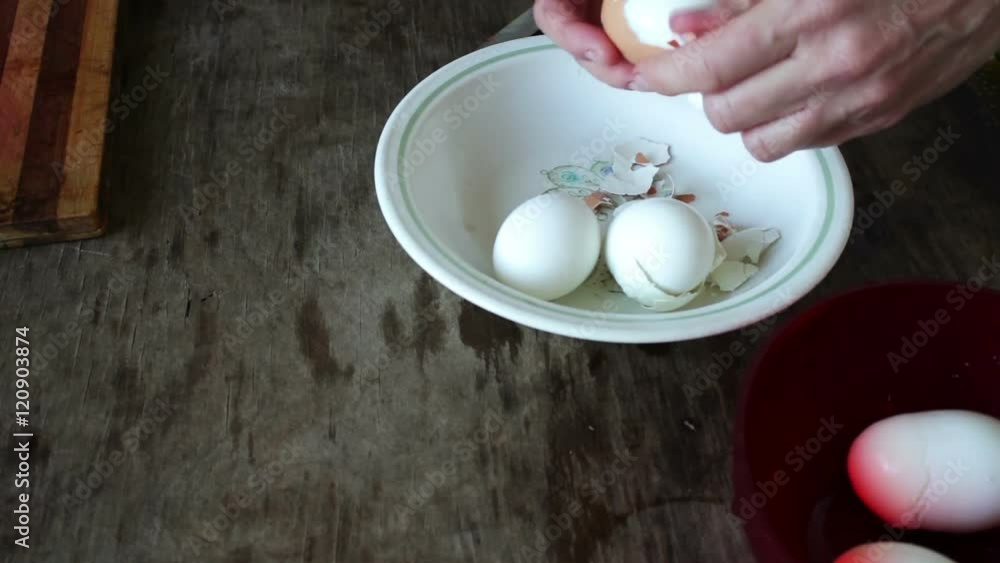 woman cleans the shell of boiled eggs woman cleans the shell of boiled eggs