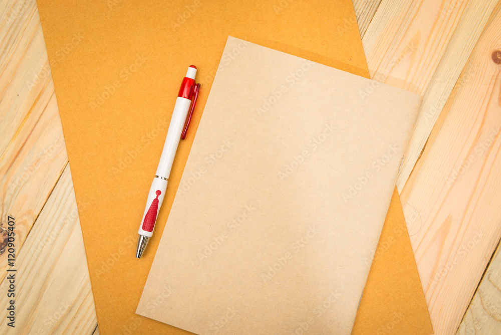 notebook and black pen with wooden background notebook and black pen with wooden background