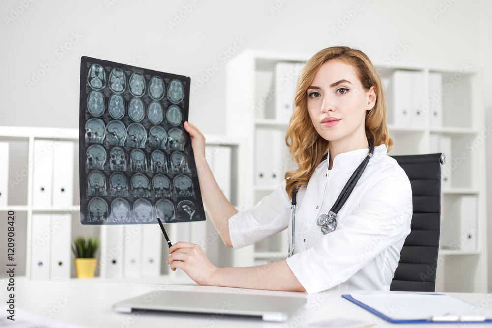 Woman doctor demonstrating brain xray Woman doctor demonstrating brain xray