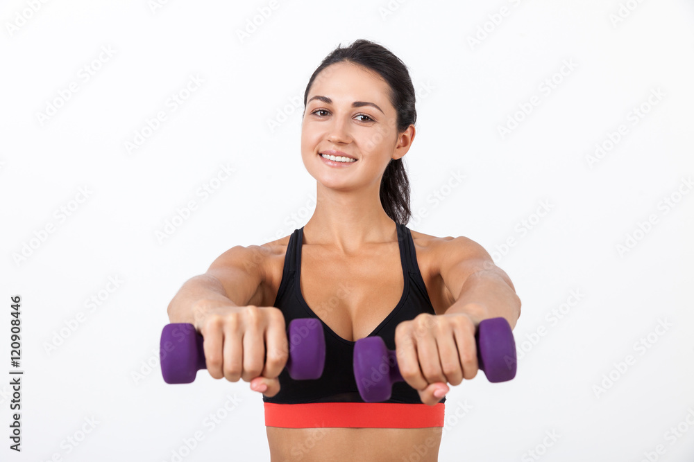 Smiling girl giving you her dumbbells Smiling girl giving you her dumbbells