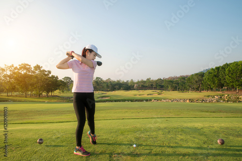 Asian woman golf hit sweeping golf course in the summer.