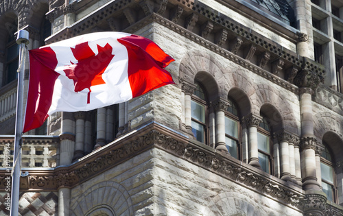 Beautiful Canada flag is waving front of a historical building