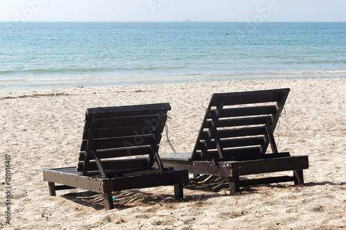 wooden beach chairs on beautiful island in white sand plage