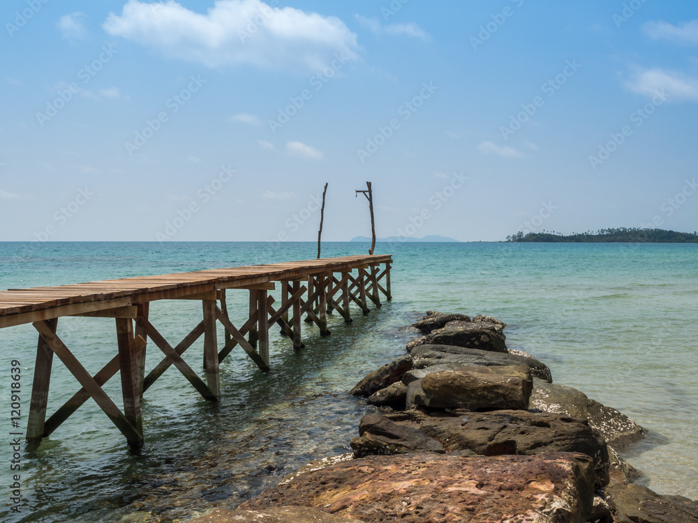 Old wooden Bridge to the blue sea