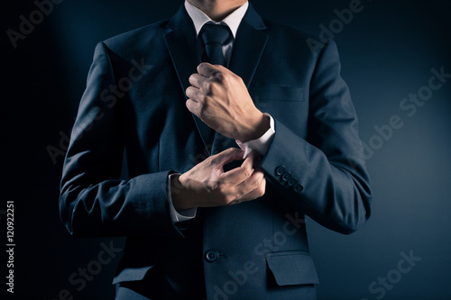Businessman Fixing Cufflinks his Suit