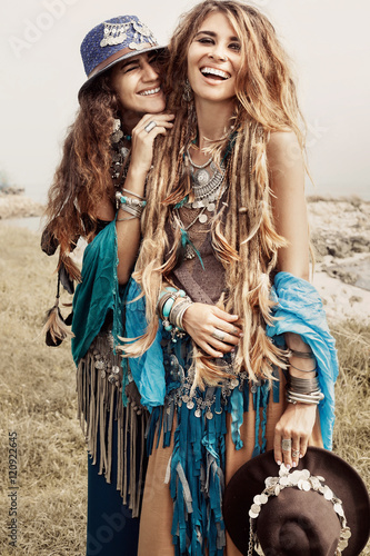 Two beautiful boho girls in ethnic jewelry outdoors