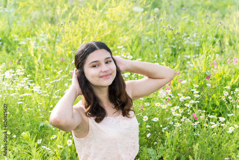 Teenage girl resting on flower meadow Teenage girl resting on flower meadow