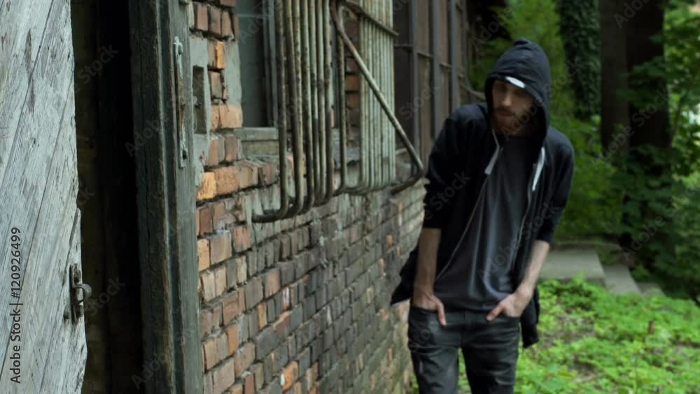 Man wearing hood and hiding in the abandoned building
Man wearing hood and hiding in the abandoned building
