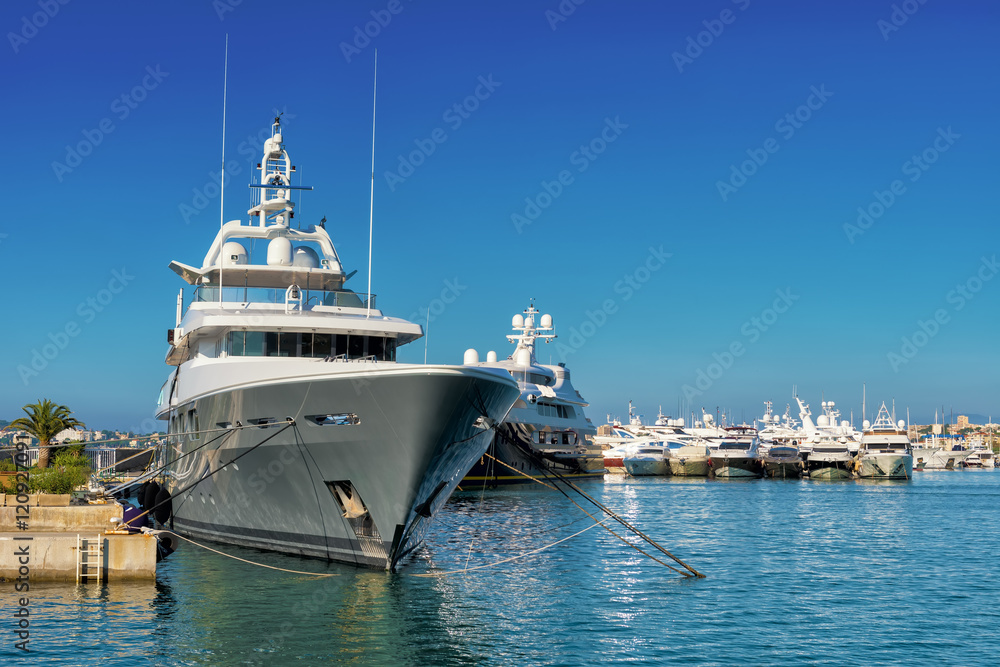 big luxury yacht moored in a marina in antibes, french riviera